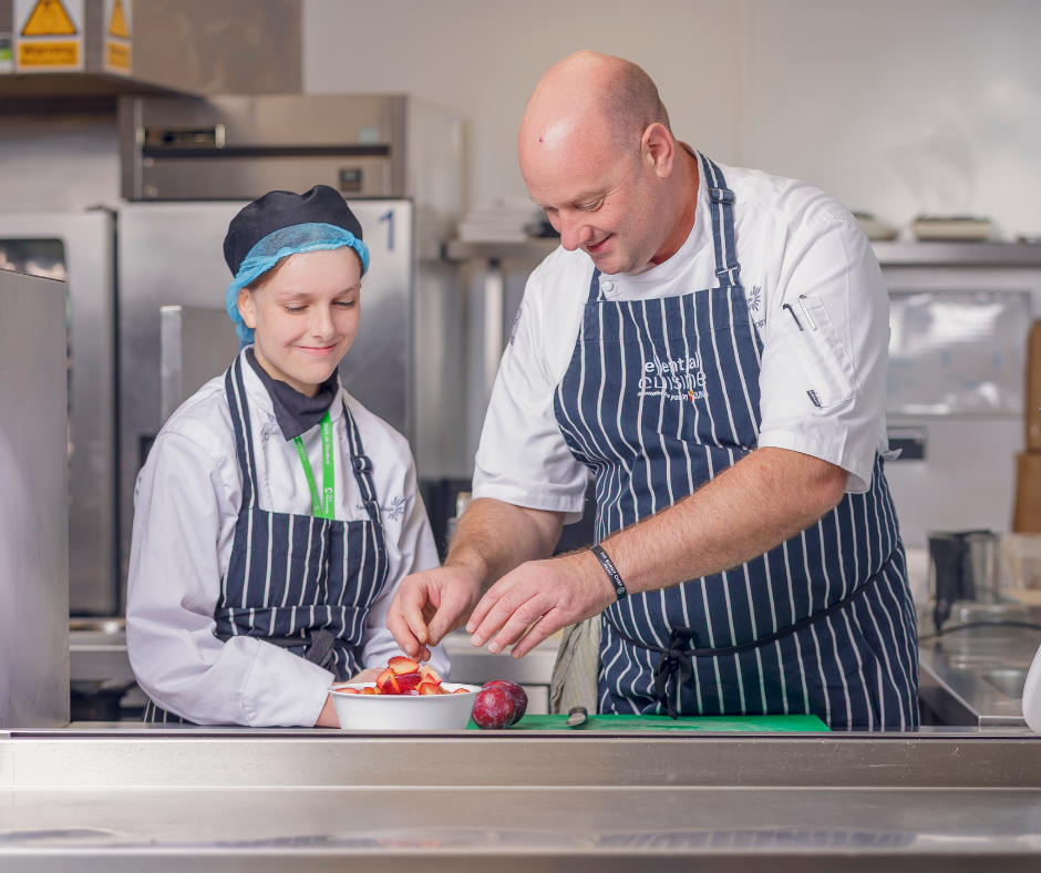 hospitality student and tutor in kitchen